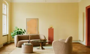 Ein Wohnzimmer mit gelben Wänden und einer grünen Decke. Die **Decke und Wand gleiche Farbe** ist hier nicht gegeben, aber die Farben harmonieren.