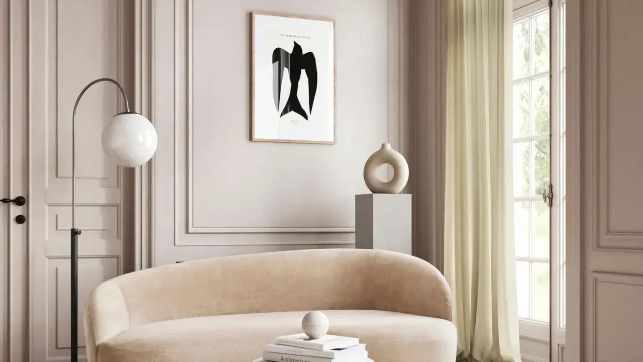 Ein Wohnzimmer mit beigem Sofa, Stehlampe und einem Bild mit einem schwarzen Vogel. Die Einrichtung zeigt, was sind neutrale farben: sanfte Beige- und Graut&ouml;ne.
